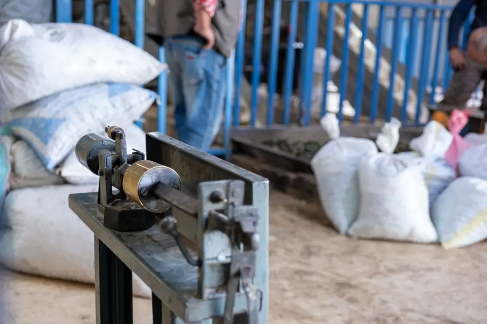 Outdated weighing scale with workers in the background